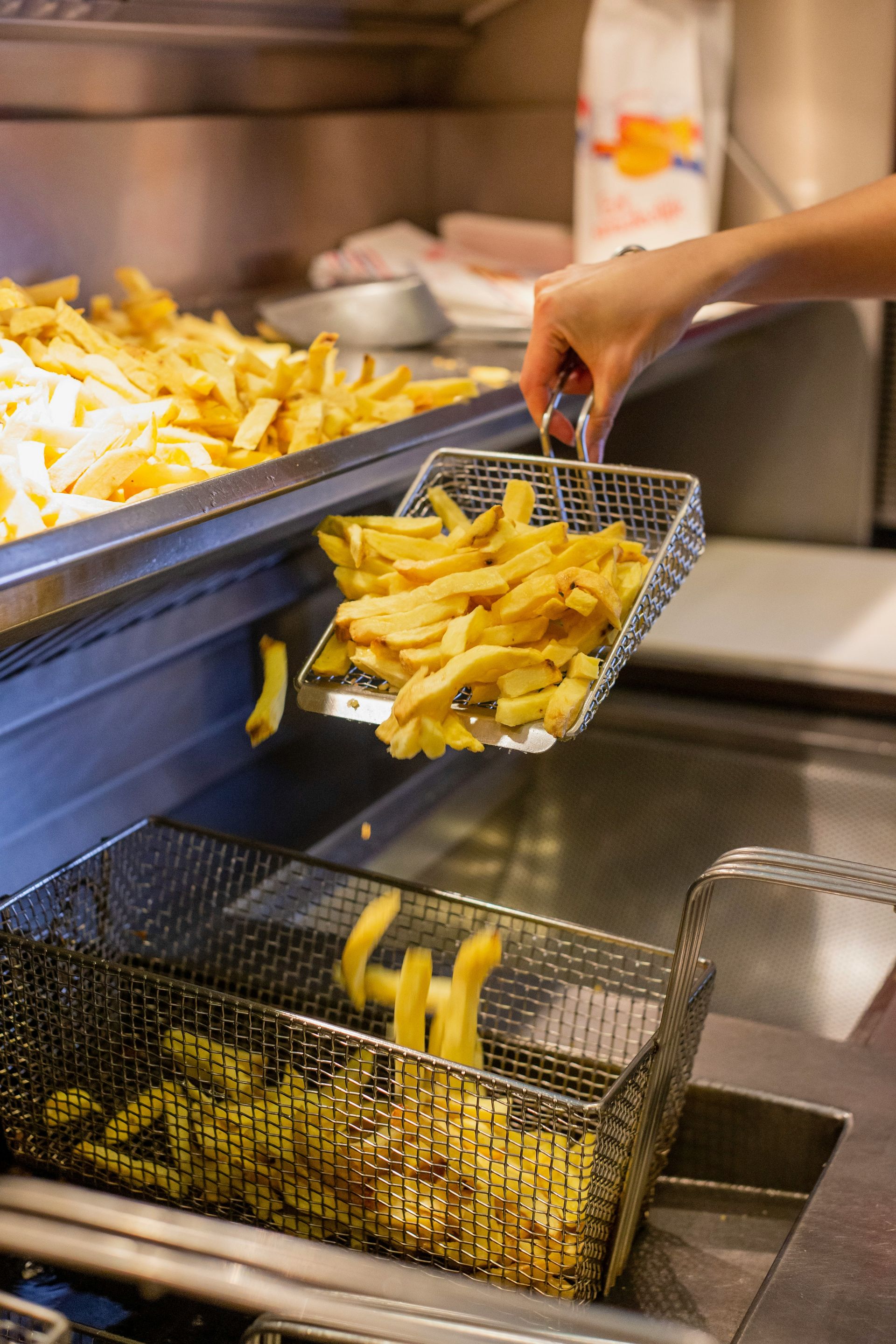 A commercial kitchen fryer in service